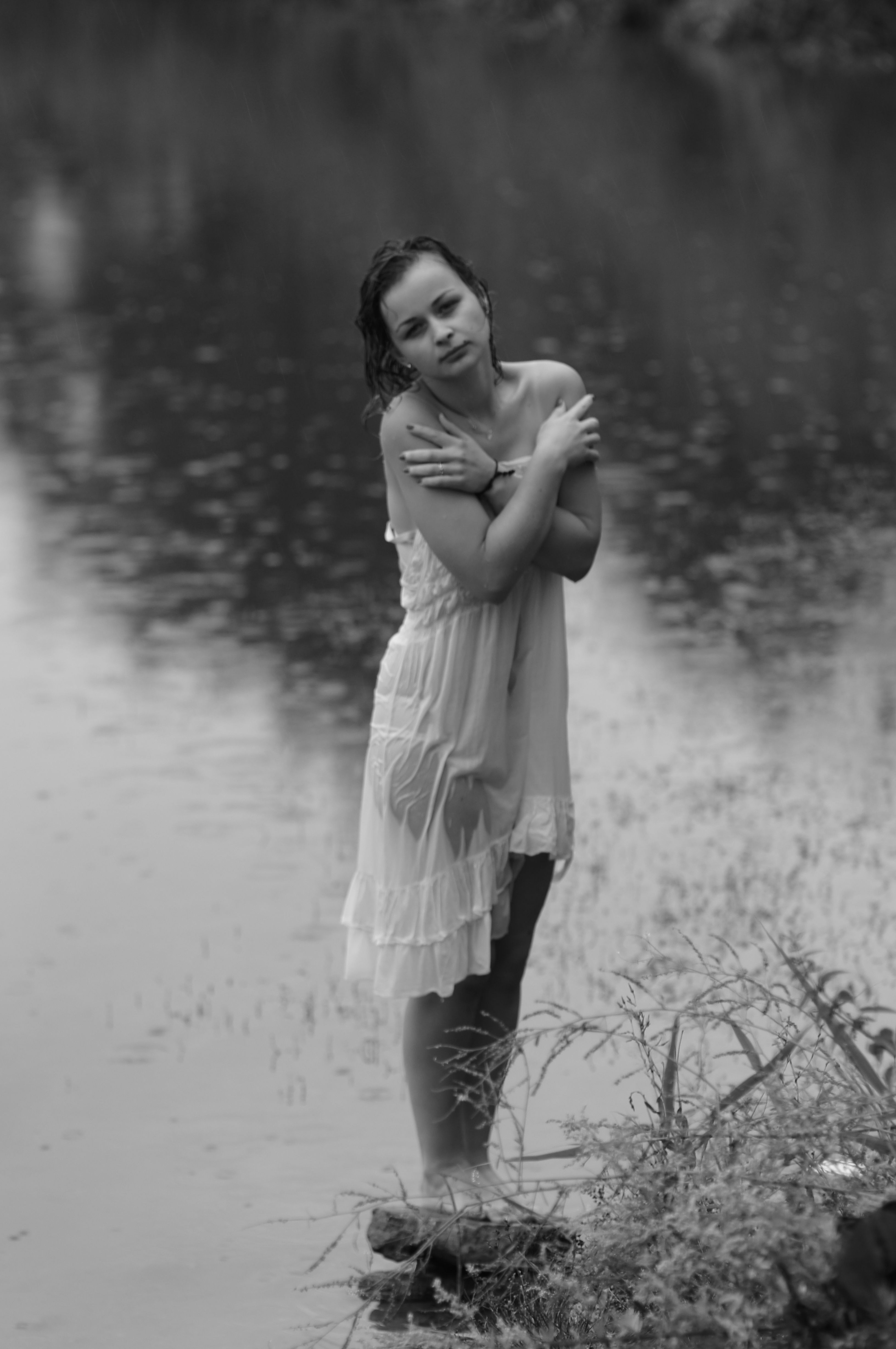 A woman in a white dress standing in the water · Free Stock Photo
