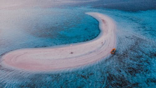 Orange Boat Moored at an Ocean Atoll Beach
