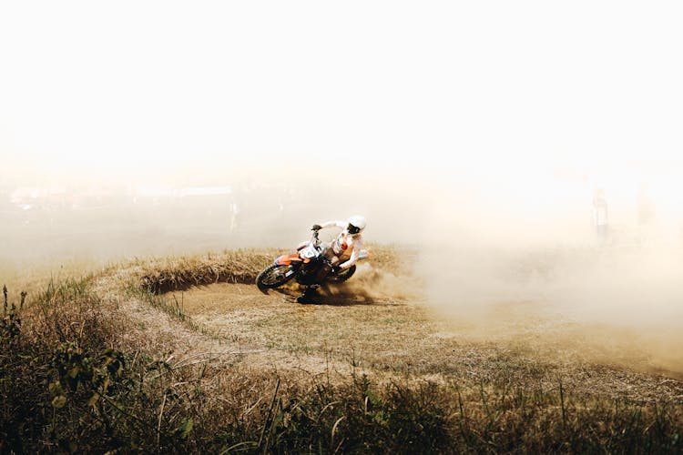 A Person Riding A Dirt Bike On A Motocross Track 