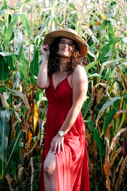 Model in Red Dress and Hat on Field