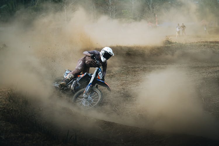 A Person Riding A Dirt Bike On A Motocross Track 