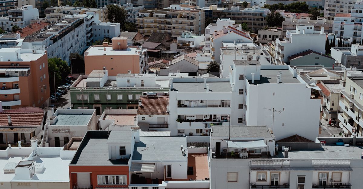 Aerial view of dense apartment blocks in Faro, capturing the urban landscape of Portugal.