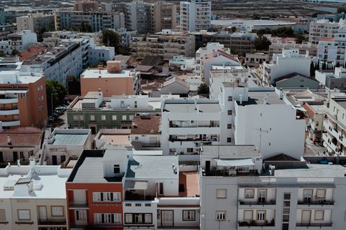 Free Aerial view of dense apartment blocks in Faro, capturing the urban landscape of Portugal. Stock Photo