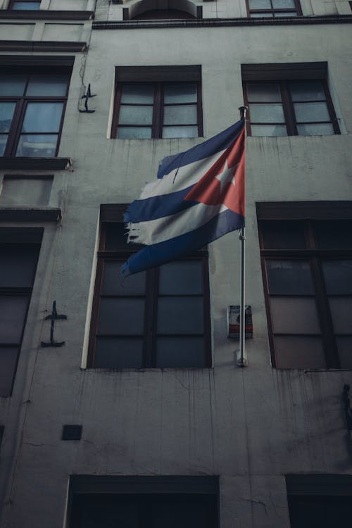 Low Angle Shot of a Building with the Cuban Flag 