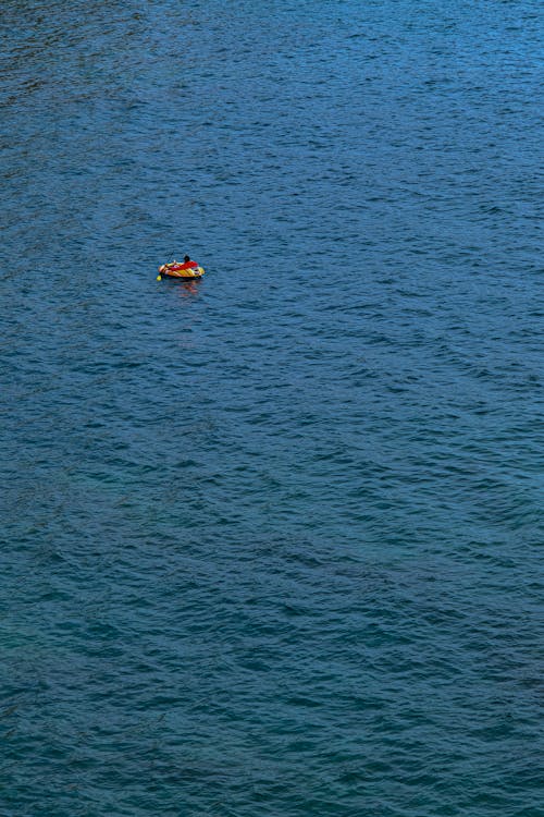 Aerial View of a Person Swimming in the Sea 