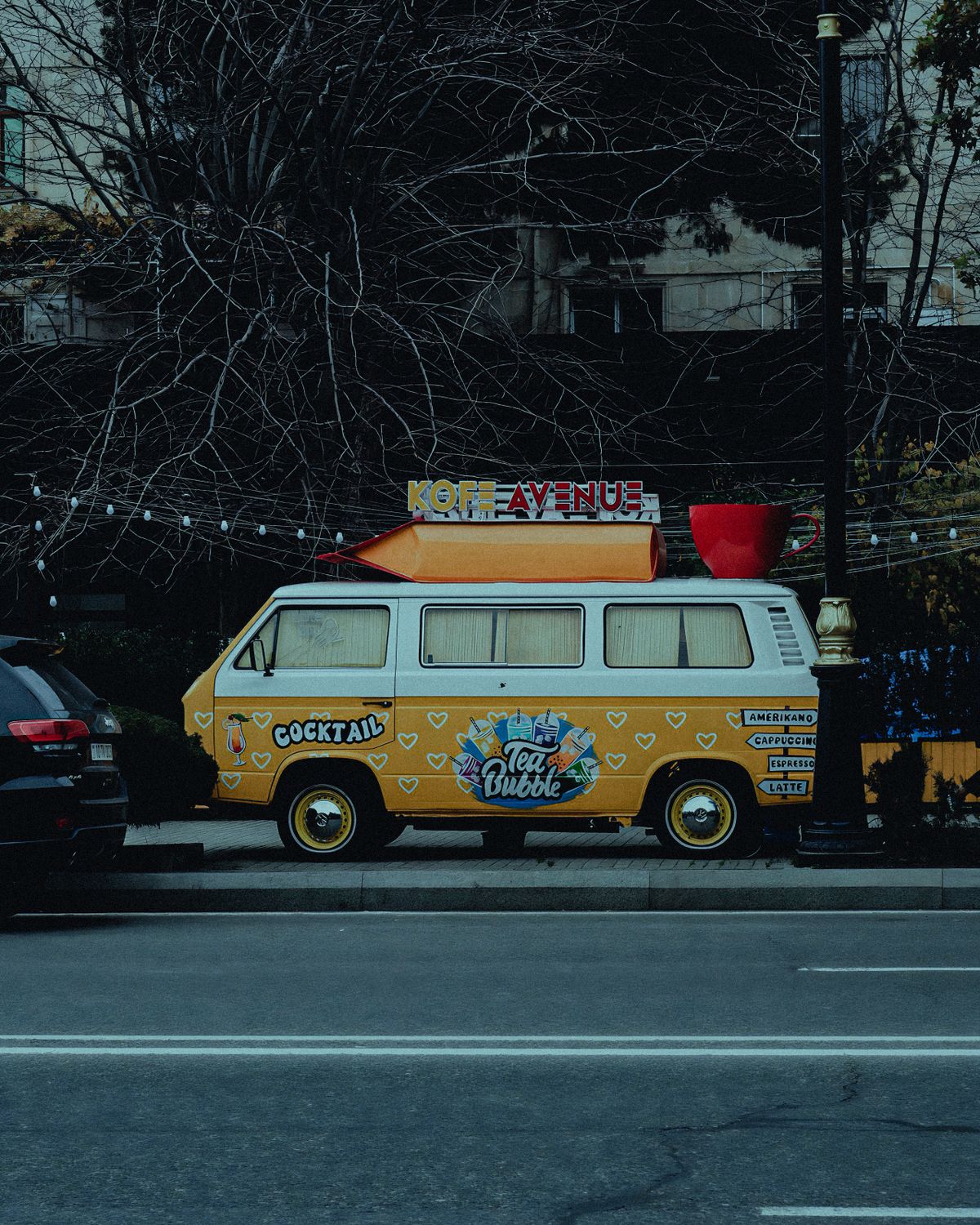 A Vintage Volkswagen Van Parked on the Side of a Street · Free Stock Photo