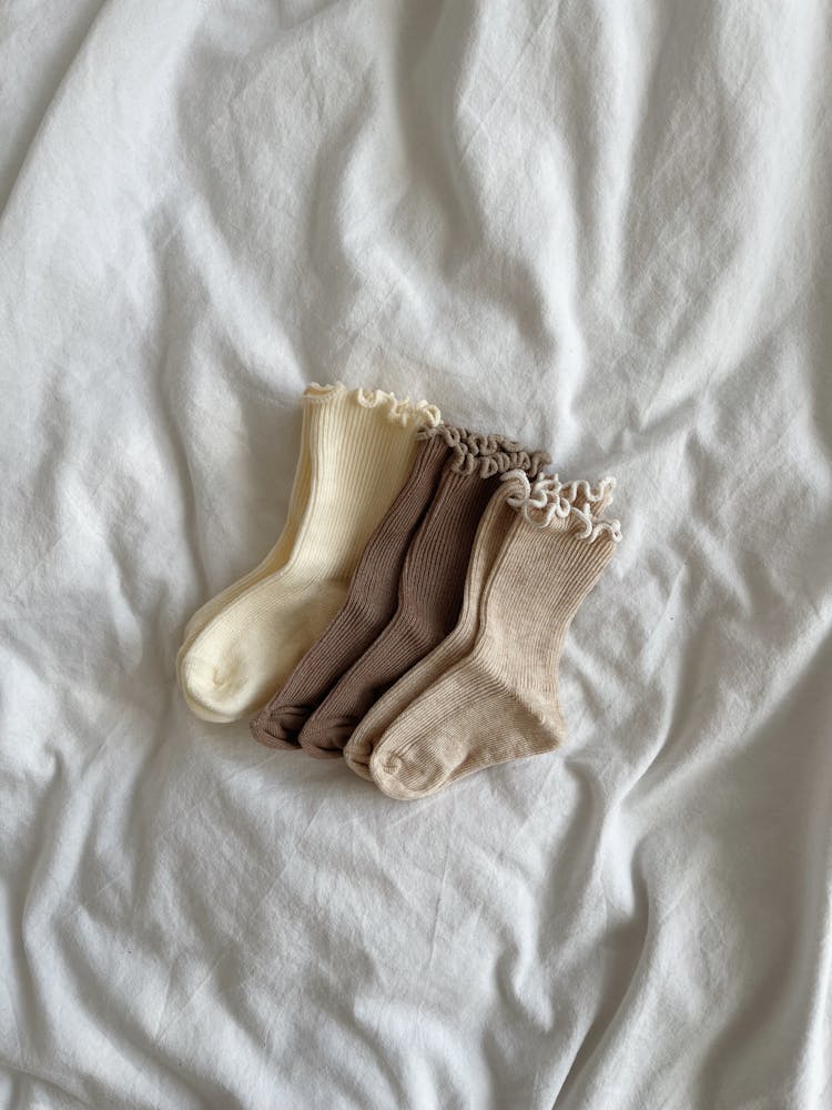 Children Socks On A Bed