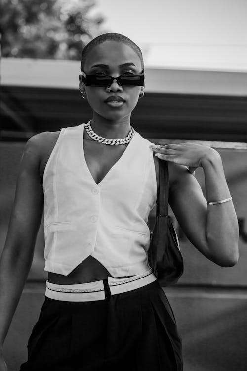 Portrait of Woman in Sunglasses and Vest in Black and White