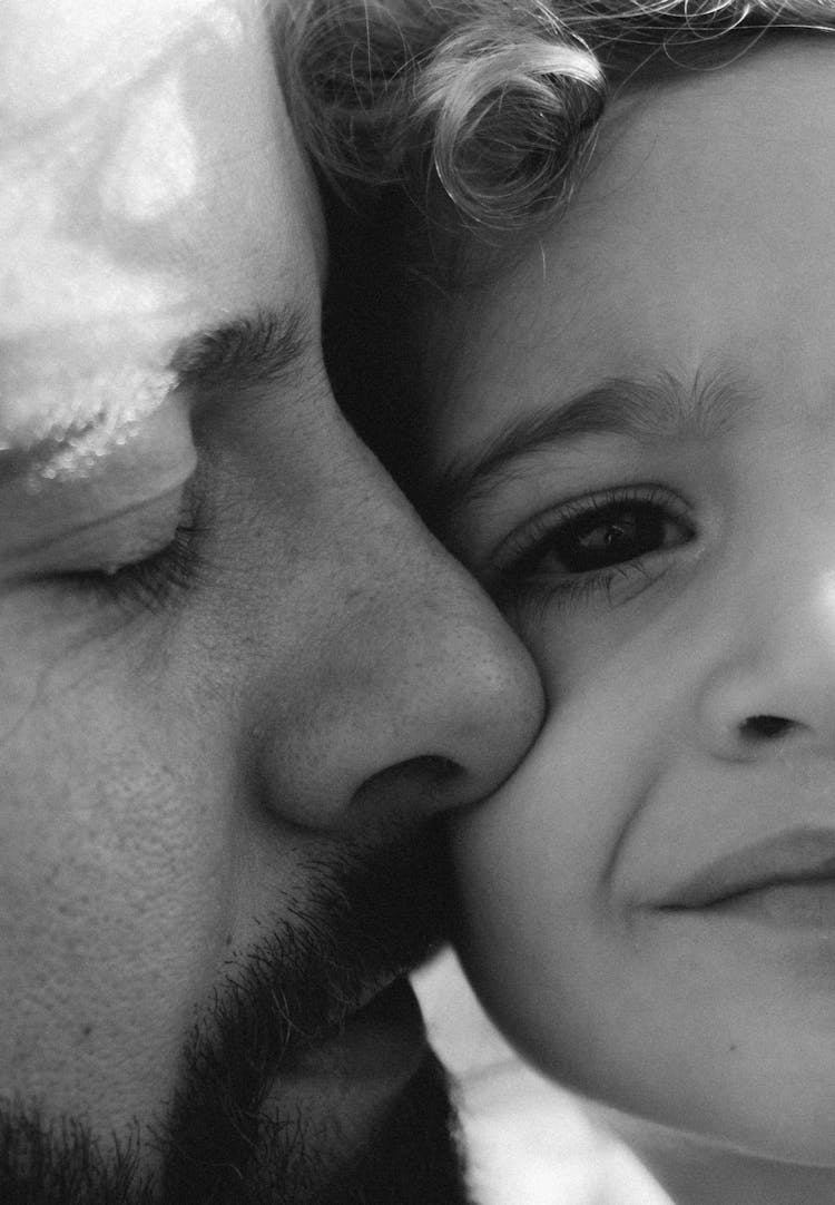 Father And Son Faces Together In Black And White