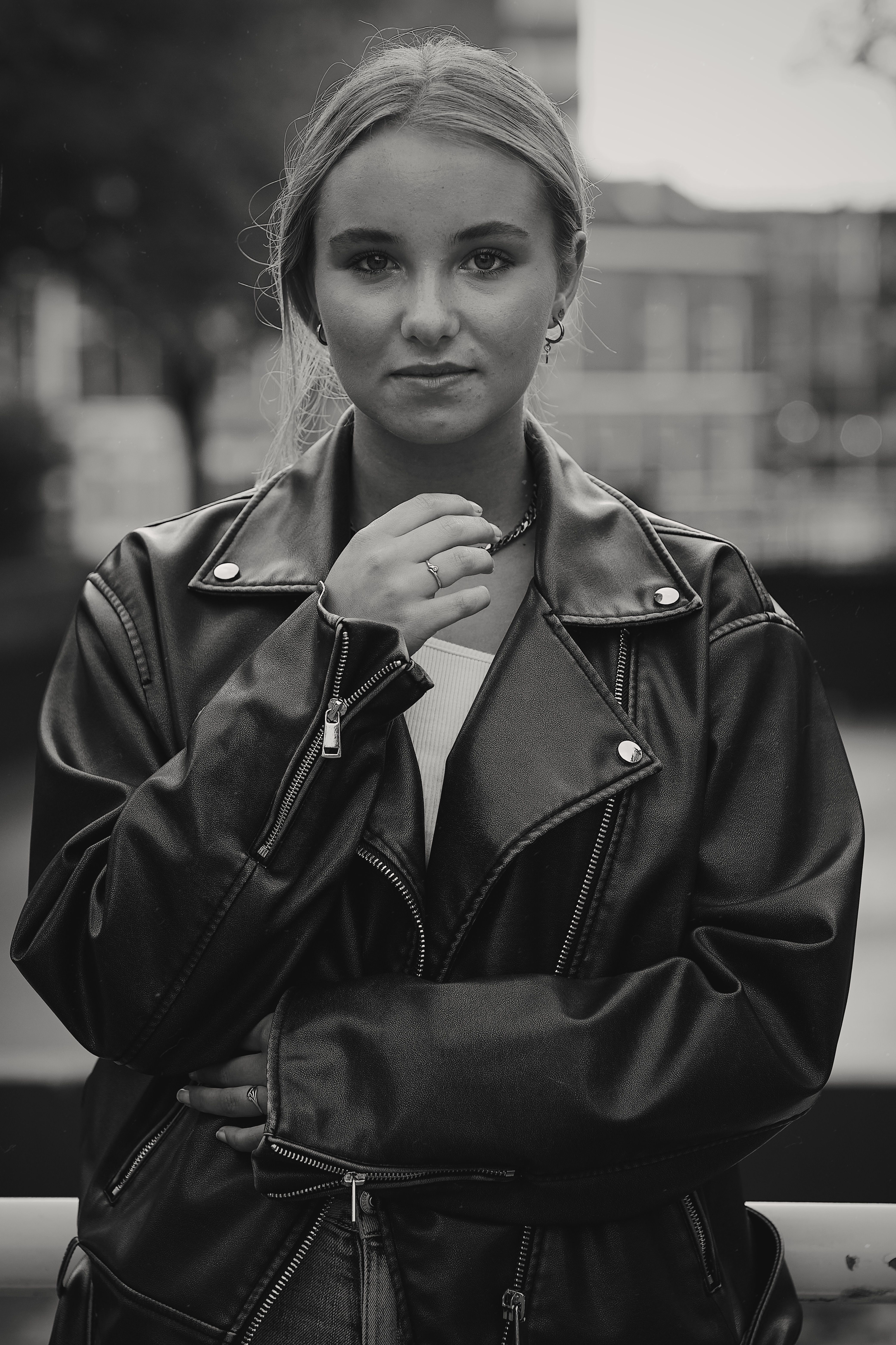 Black and White Photo of a Young Woman in a Leather Jacket Standing ...