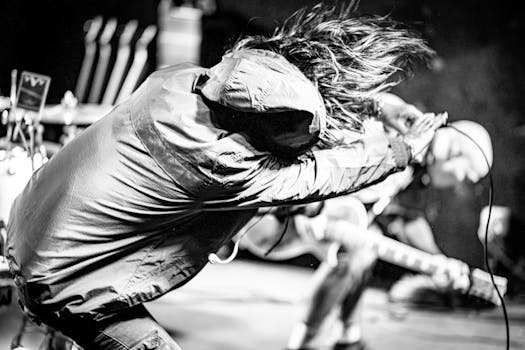 A high-energy black and white image of musicians performing live on stage, capturing the essence of a rock concert.