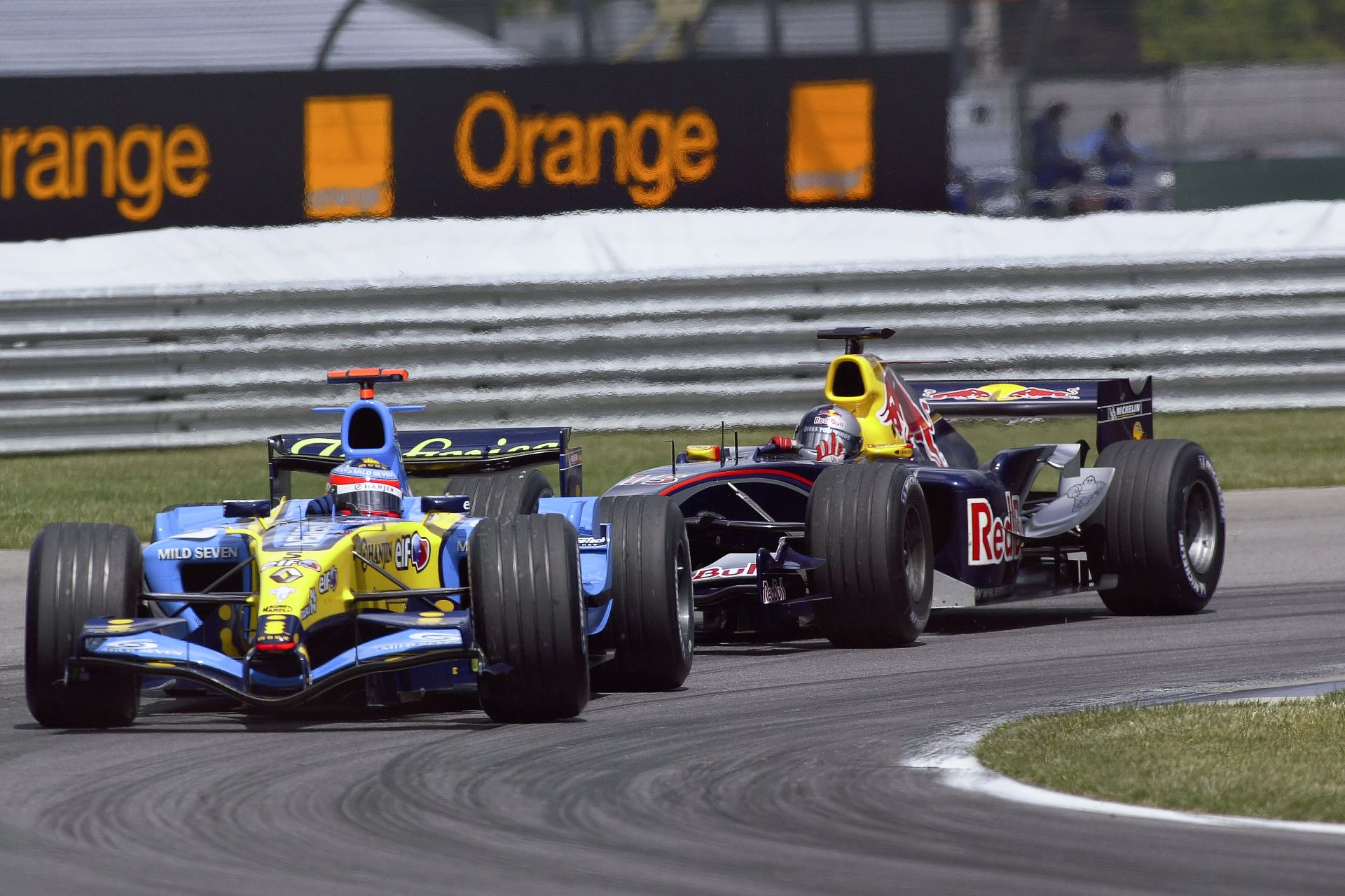 A Renault R25 and Red Bull RB1 Racing on the Track at a Grand Prix in 2005