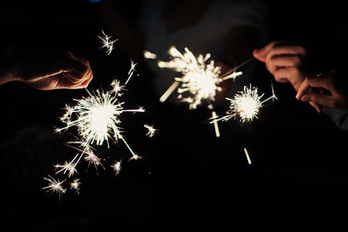 Close-up of People Holding Sparklers 