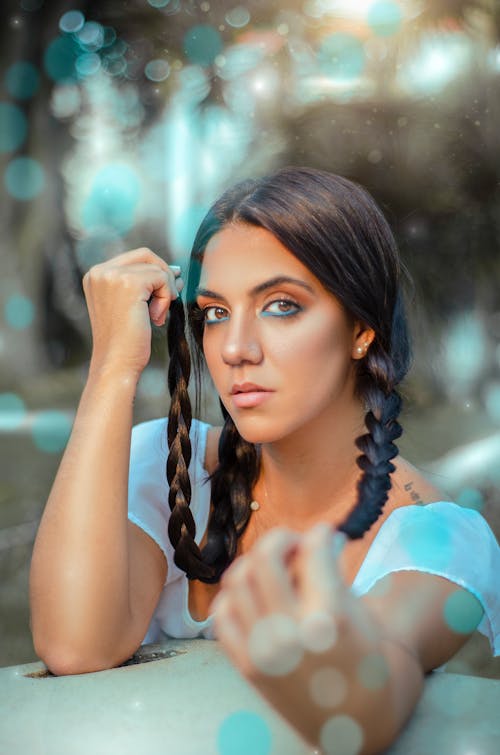 Young Woman with Braided Hair Standing Outside 