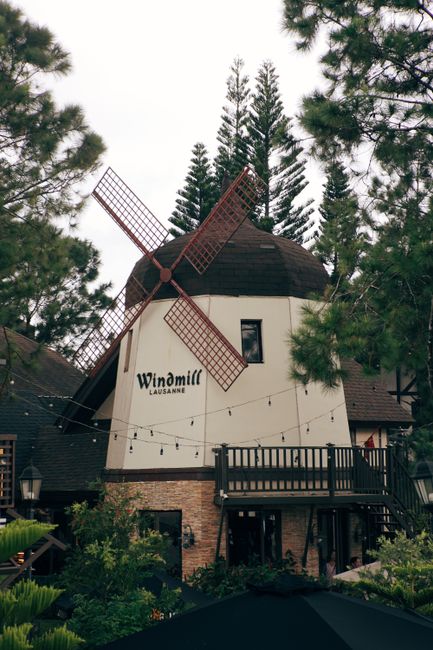 Charming windmill-themed restaurant amidst pines in Tagaytay, Philippines.