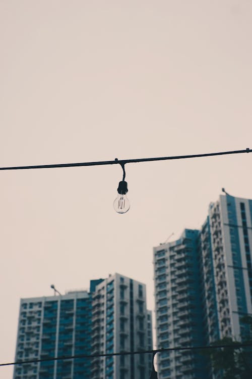 LED Imitating a Classic Bulb in String Lighting Hung over the Sidewalk