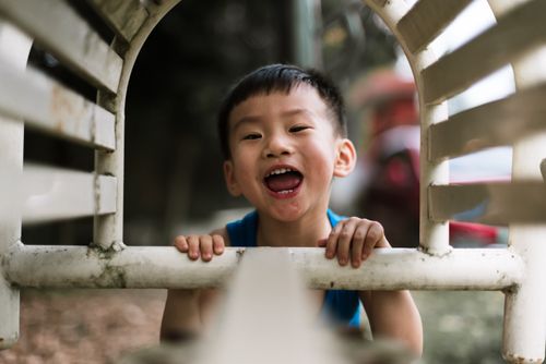 Free Happy child with short hair enjoying playtime outdoors on a summer day. Stock Photo