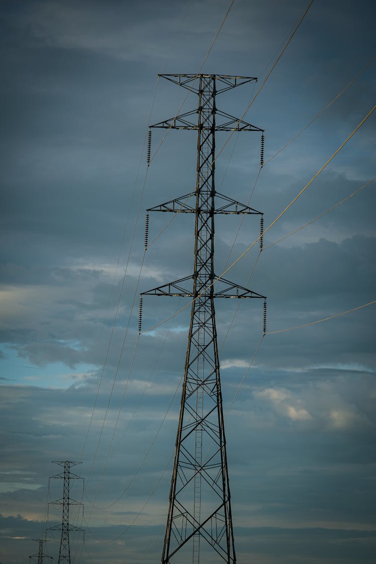 Electricity Pole On A Field 