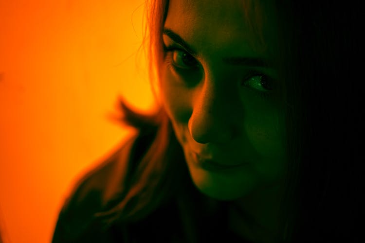 Portrait Of A Young Woman In Orange Light 