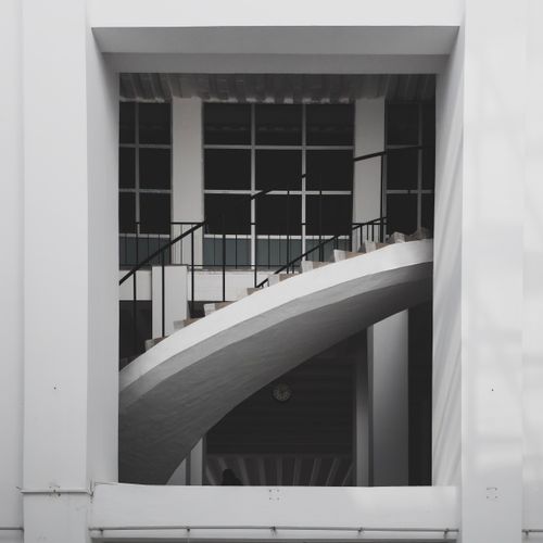 Free A minimalistic view of a modern stairway with geometric design elements and railings. Stock Photo