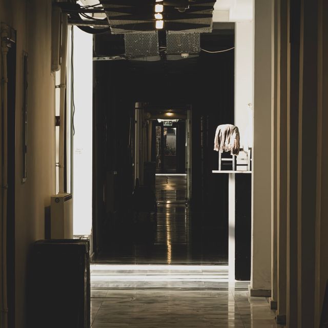 Dim interior corridor at night, photo by Yigit Karaalioglu on Pexels
