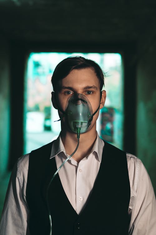 Man in Shirt with Vest and in Oxygen Mask