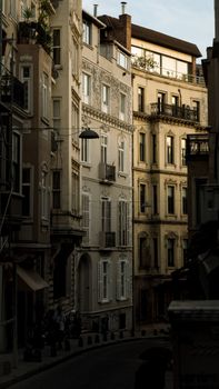 Photograph of a narrow urban alley lined with historic terraced houses in soft lighting.