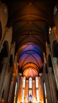 Stunning view of a cathedral interior with illuminated altar and intricate ceiling architecture.