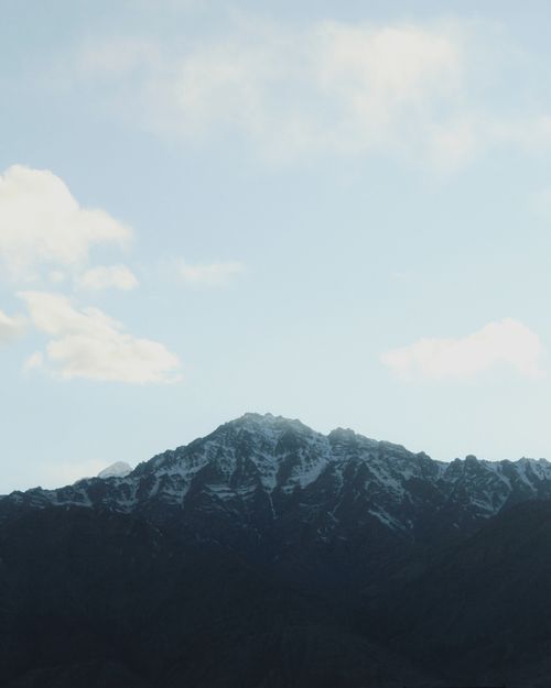 Free Breathtaking view of snow-capped mountain peaks against a clear blue sky, perfect for winter or travel themes. Stock Photo
