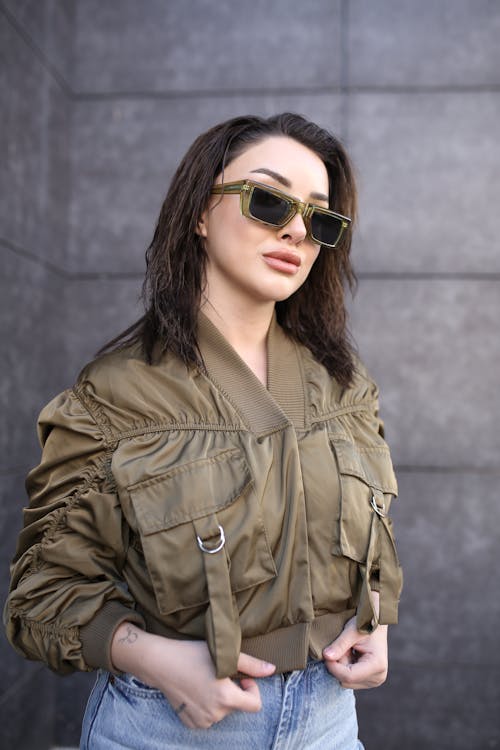 Young Brunette Woman Posing in Green Sunglasses and Green Jacket