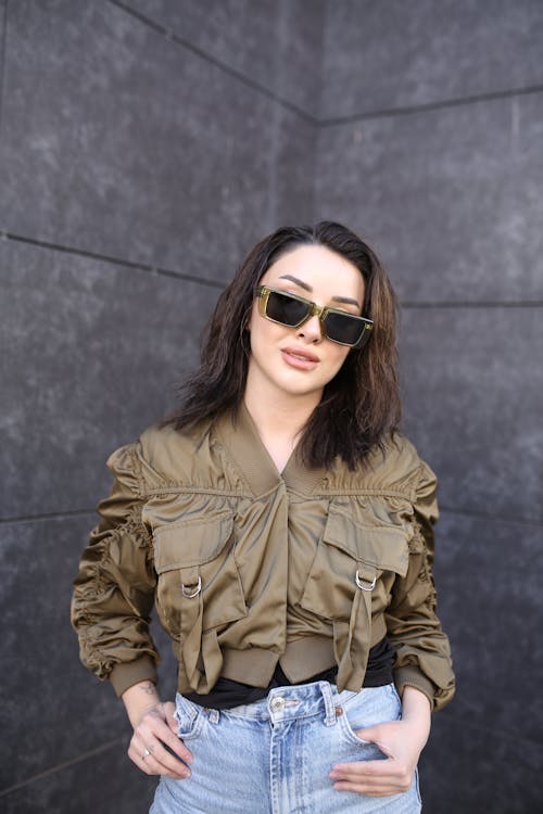 Young Brunette Woman Posing in Green Sunglasses and Green Jacket