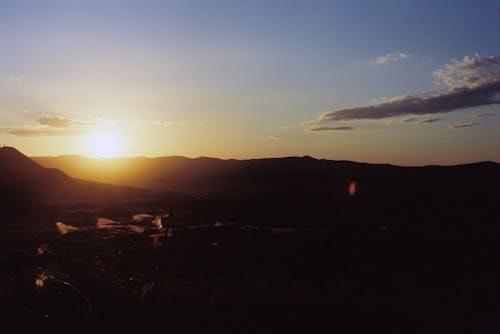 Free Landscape of a Sunset Behind the Mountains Stock Photo