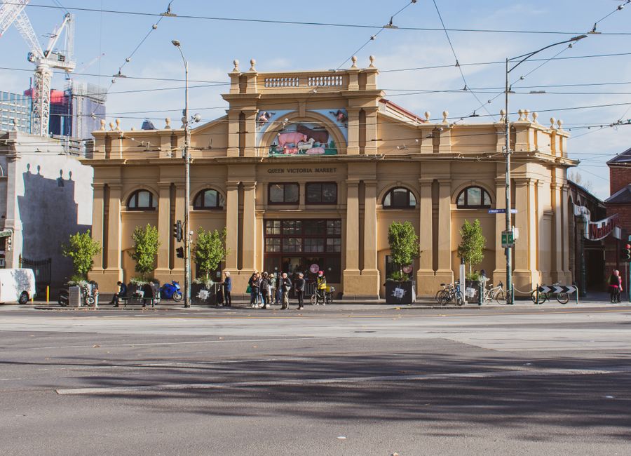 Street view of Queen Victoria Market with people and bicycles in Melbourne, Australia.