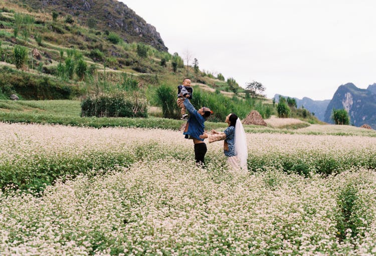 Parents With Their Child On A Field