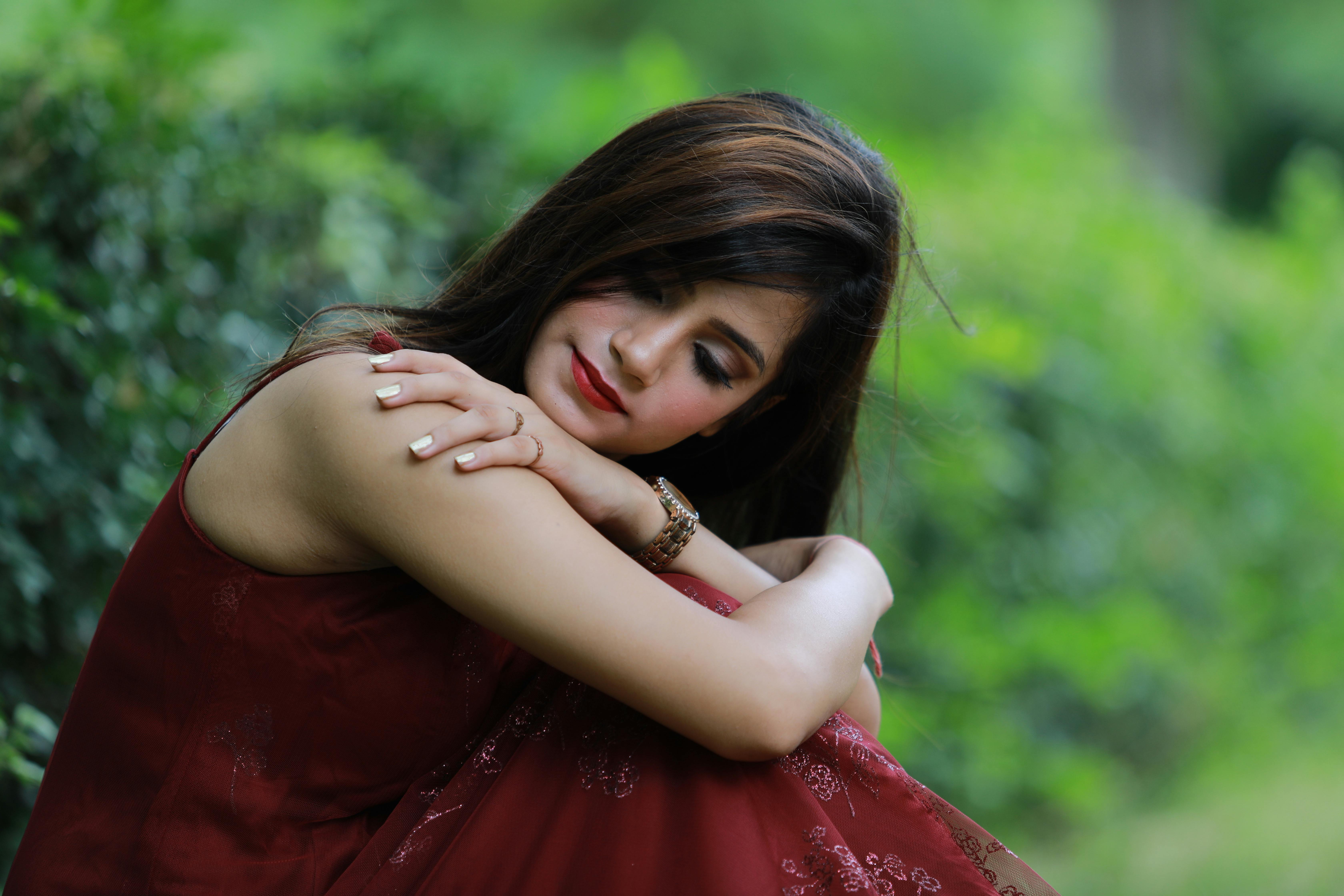 woman wearing burgundy dress in a park