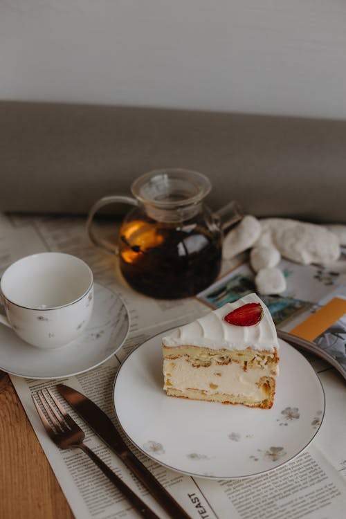 A Slice of Cake with Cream Filling on a Plate 