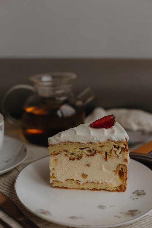 A Slice of Cake and Teapot on the Table 