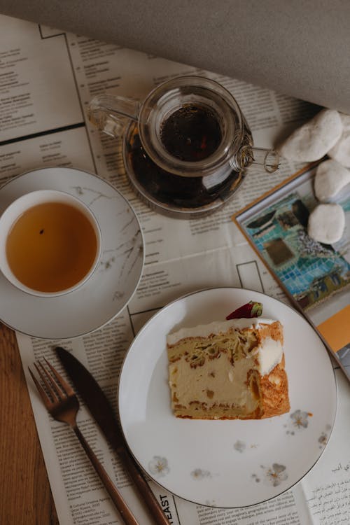 A Slice of Cake and a Cup of Tea on the Table 