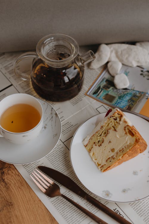 A Slice of Cake and a Cup of Tea on the Table 