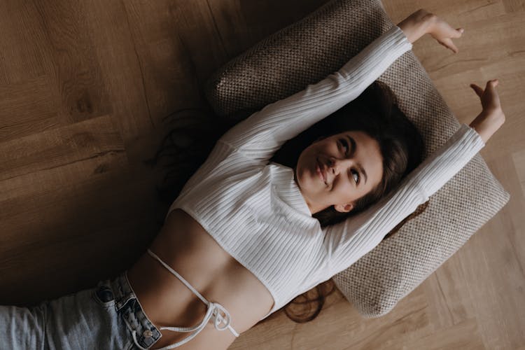 A Woman Stretching On A Floor