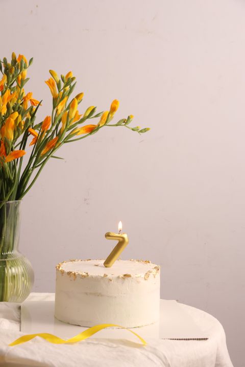 Eggless Celebration Cakes: 5 Recipes That Work Every Time for Any Occasion 2 Flat lay of five different decorated eggless cakes on a festive table with flowers and diyas