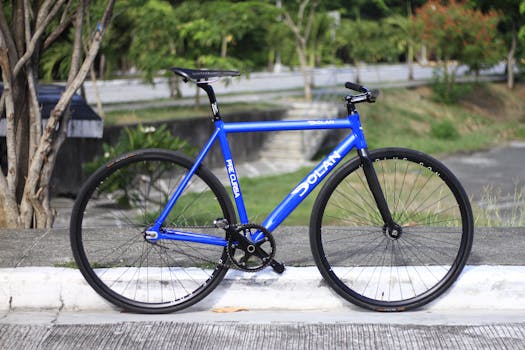 A sleek blue road bicycle parked on the pavement, ideal for cycling enthusiasts.