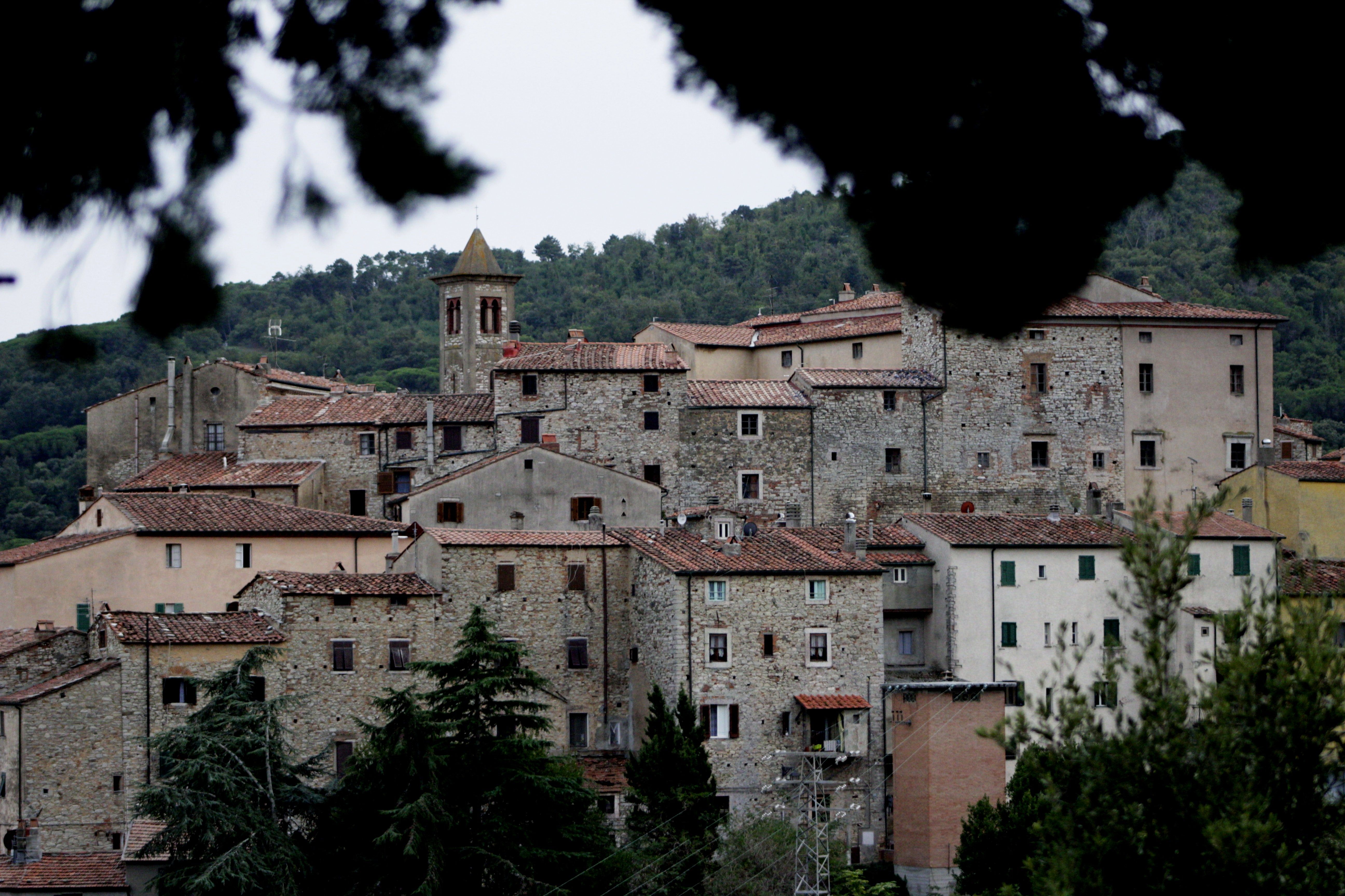 Charming old European village with rustic stone buildings and scenic landscape.