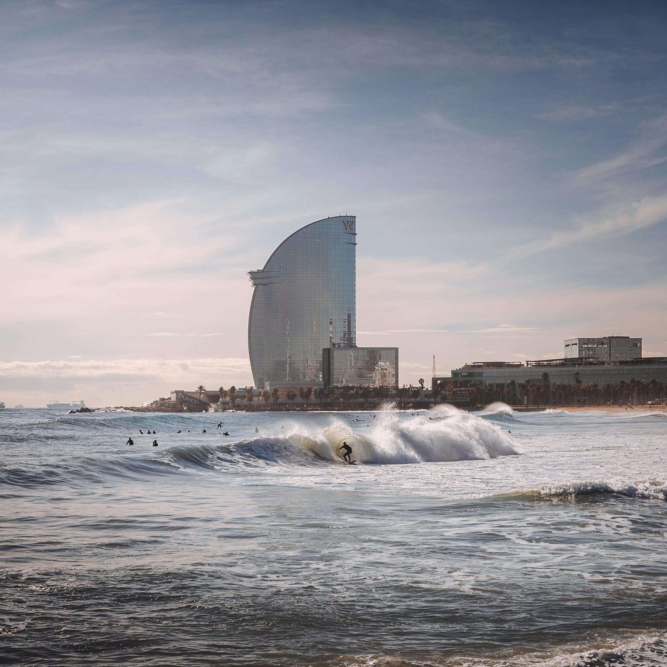 Person Surfing With High-rise Building Background