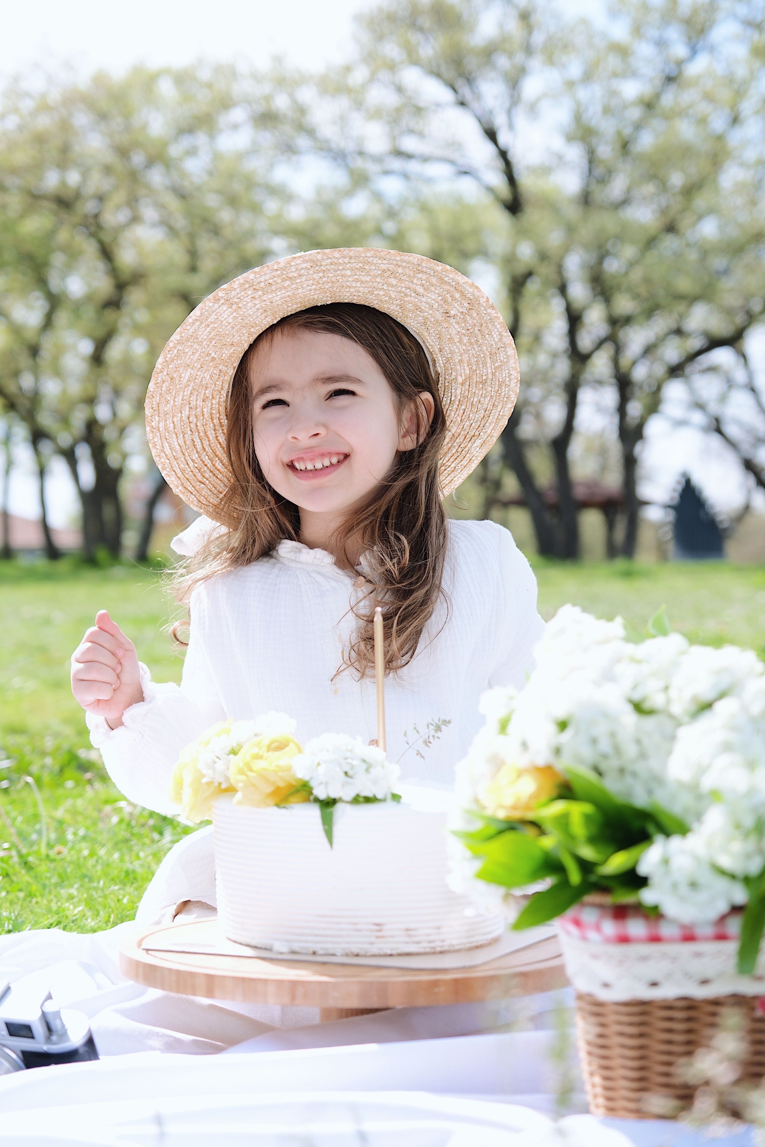 Happy Girl in White Dress Sitting at Picnic · Free Stock Photo