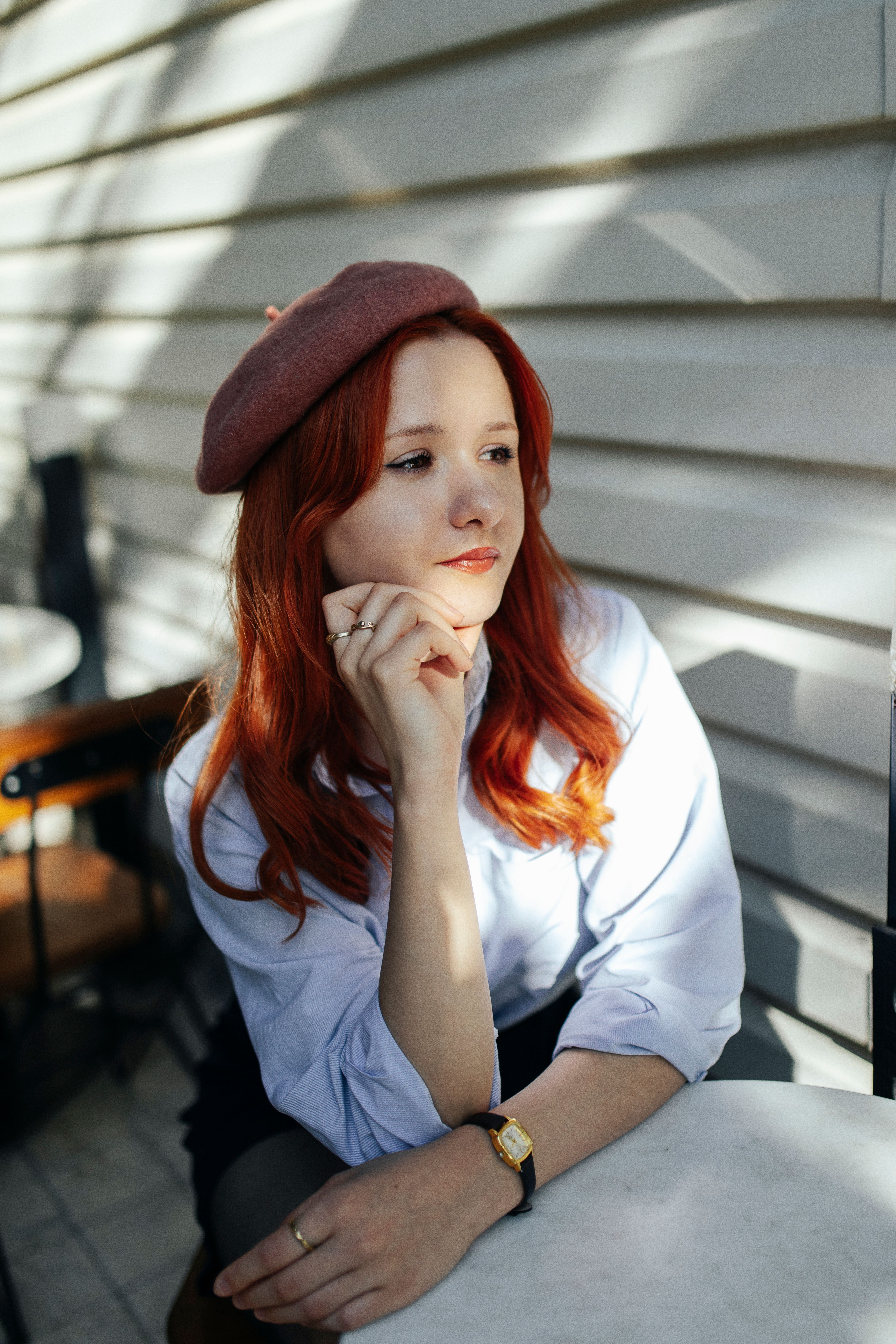Portrait of a Pretty Redhead Sitting Outdoors · Free Stock Photo