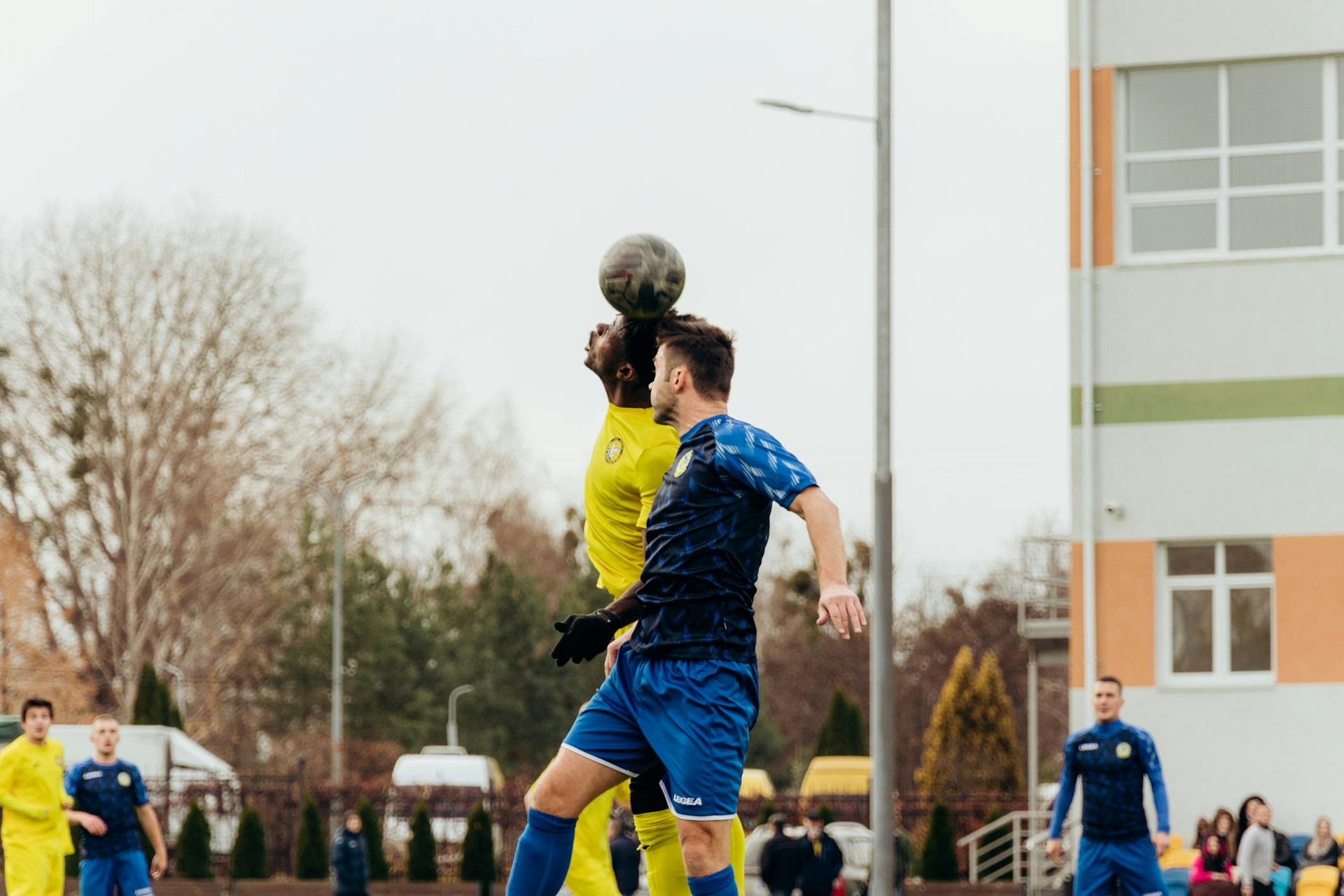 Action-packed soccer match with players heading the ball in Kyiv, Ukraine outdoors.