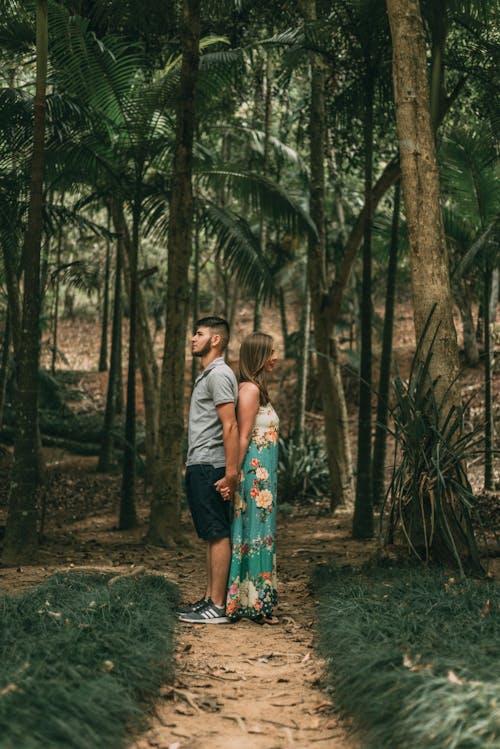 Free Photo Of Couple Standing In The Middle Of Forest Stock Photo