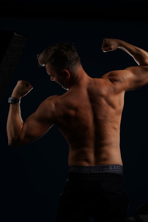 Free Shirtless Man Flexing Muscles Stock Photo