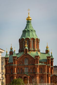 Capture of the majestic Uspenski Cathedral in Helsinki, showcasing its architectural beauty against a clear sky.